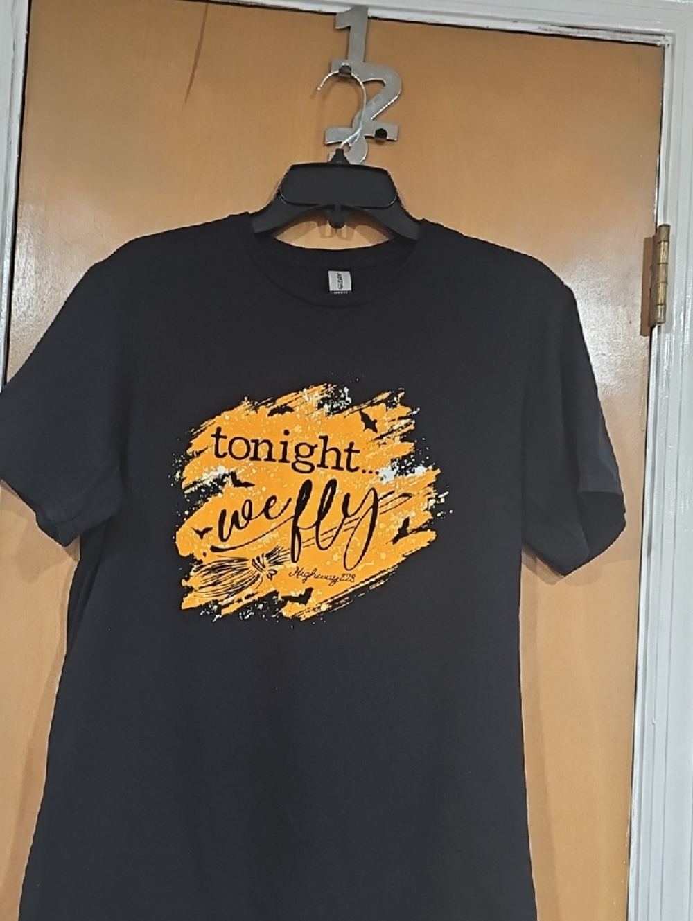 Men's Black Graphic Tee with Yellow Script Design